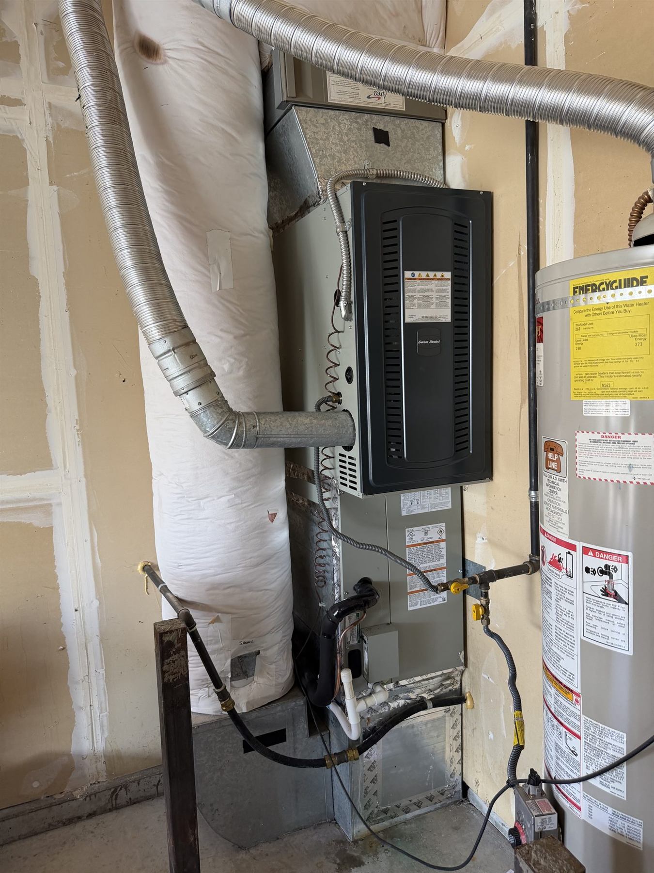 A furnace and ductwork in a home utility space