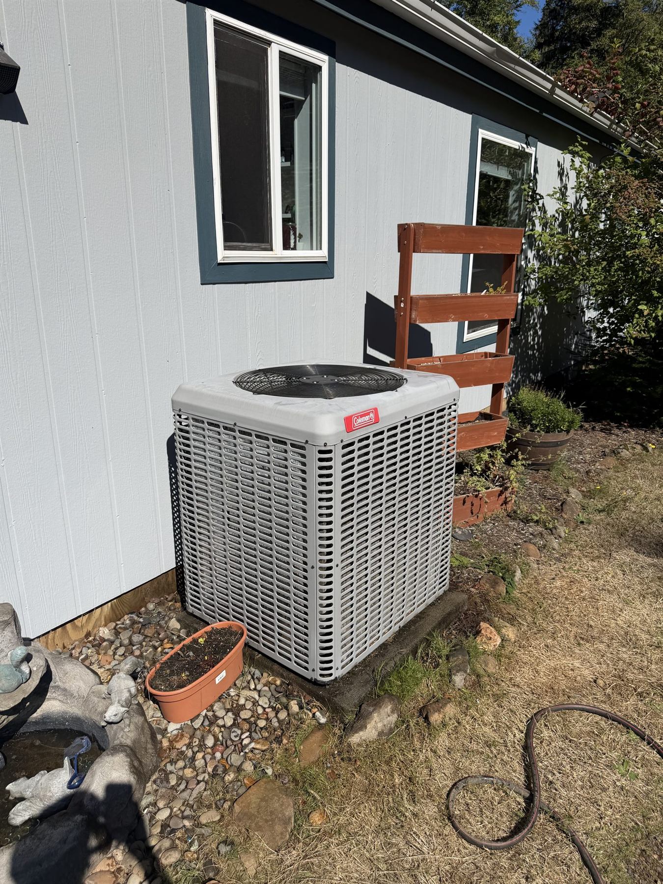 A Goodman outdoor unit beside a house