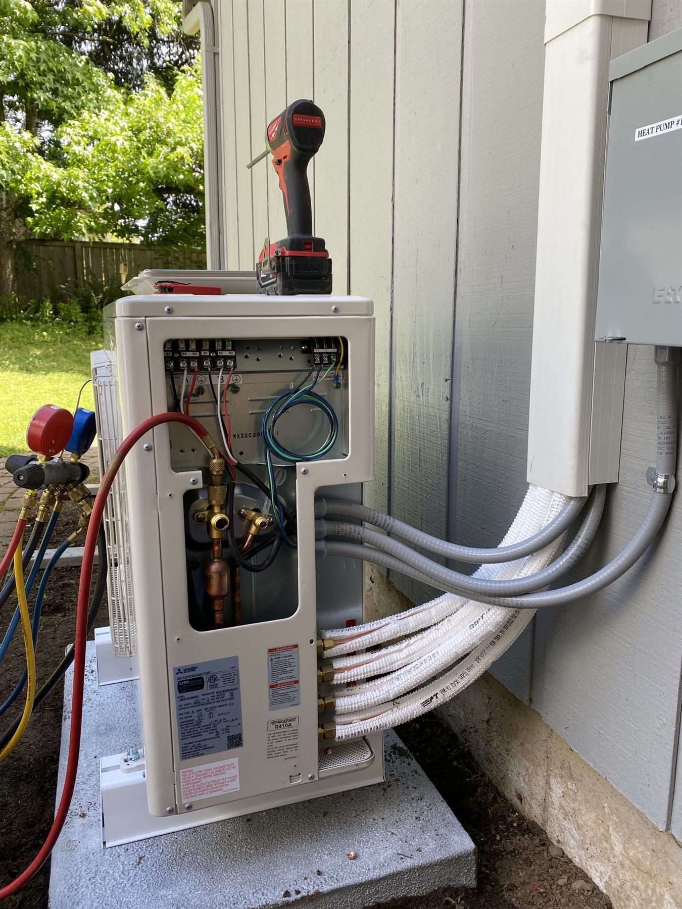 Gauges connected to an outdoor unit during a service visit