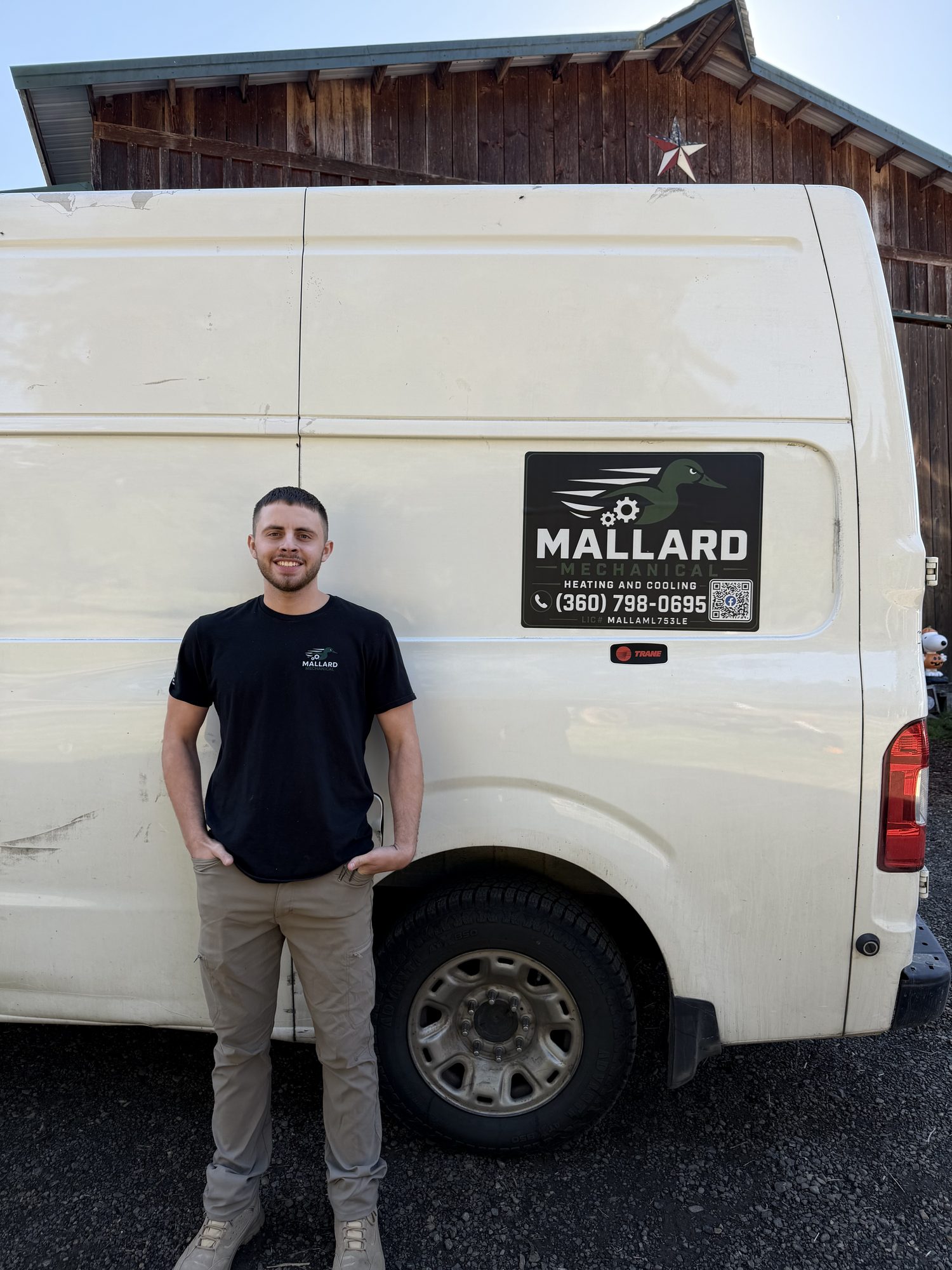 A Mallard Mechanical technician beside the service van