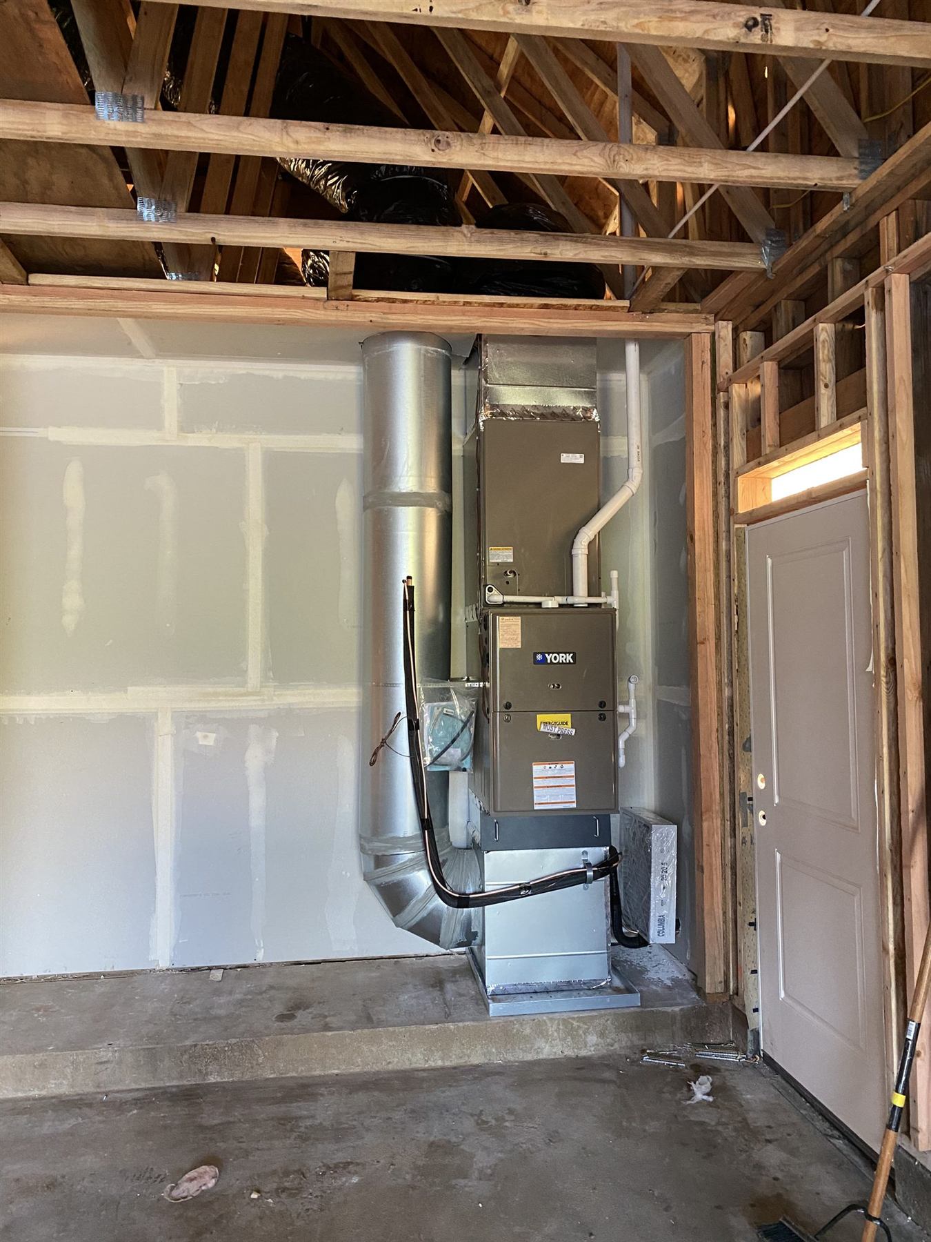 A finished furnace and ductwork in a new house